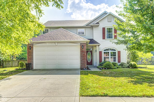 1143 Kinross Dr, Avon, IN 46123 - traditional-style house with roof with shingles, driveway, a garage, and brick siding