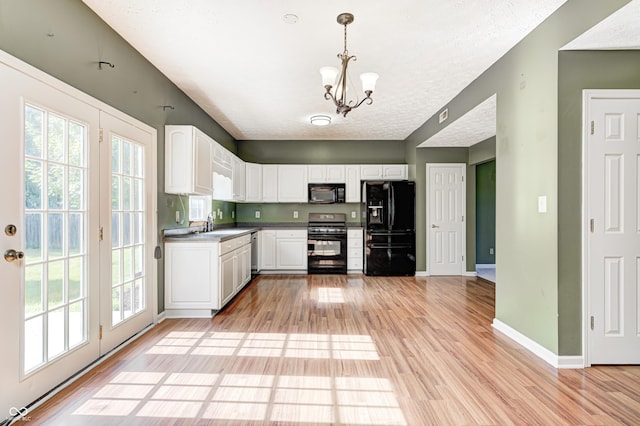 1143 Kinross Dr, Avon, IN 46123 - kitchen featuring light wood-type flooring, black appliances, and a chandelier