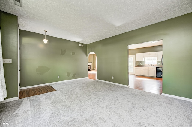 1143 Kinross Dr, Avon, IN 46123 - spare room with arched walkways, carpet, and a textured ceiling