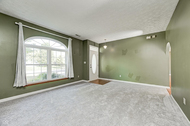 1143 Kinross Dr, Avon, IN 46123 - carpeted foyer with arched walkways and a textured ceiling