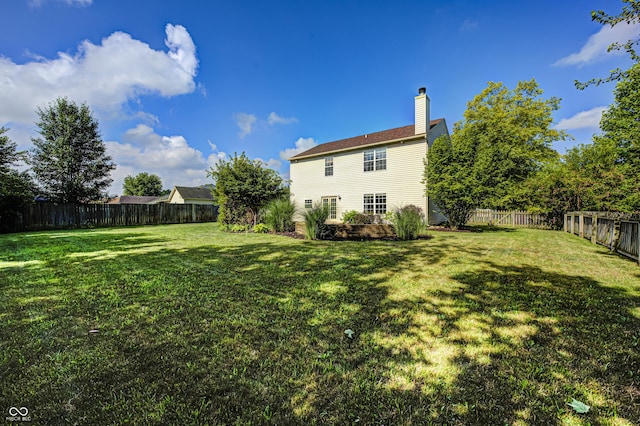 1143 Kinross Dr, Avon, IN 46123 - rear view of property with a fenced backyard and a chimney