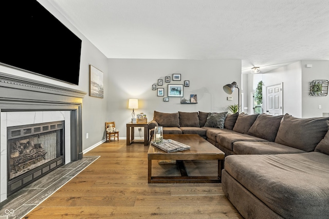 8612 Weaver Woods Pl, Fishers, IN 46038 - living room with wood finished floors, a tile fireplace, and a textured ceiling