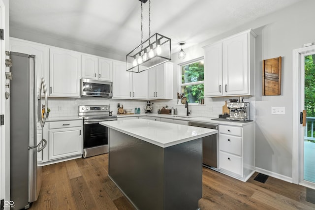 8612 Weaver Woods Pl, Fishers, IN 46038 - kitchen with appliances with stainless steel finishes, backsplash, dark wood-type flooring, and white cabinetry