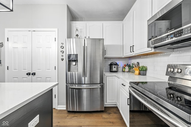 8612 Weaver Woods Pl, Fishers, IN 46038 - kitchen featuring stainless steel appliances, dark wood-type flooring, white cabinets, and decorative backsplash