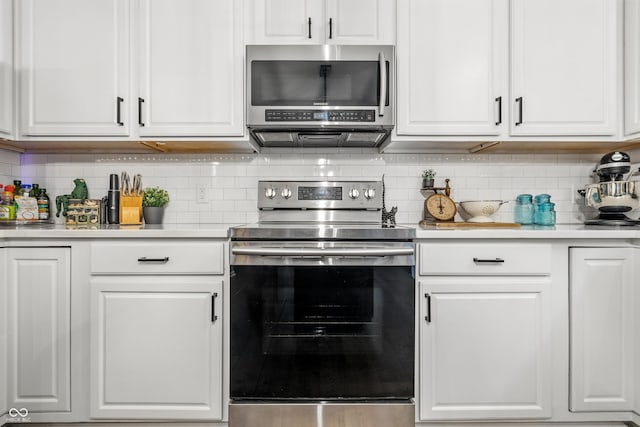 8612 Weaver Woods Pl, Fishers, IN 46038 - kitchen featuring stainless steel appliances, light countertops, white cabinets, and backsplash