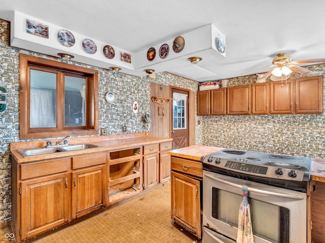 4484 S County Road 315 W, Greencastle, IN 46135 - kitchen with stainless steel electric range oven, a ceiling fan, light countertops, decorative backsplash, and brown cabinetry