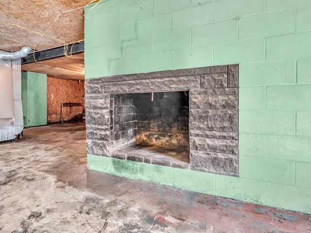 4484 S County Road 315 W, Greencastle, IN 46135 - detailed view of unfinished concrete floors, concrete block wall, and a fireplace with raised hearth