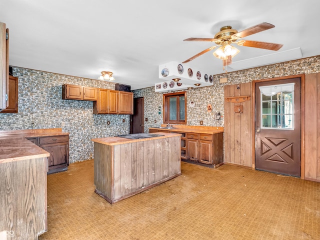 4484 S County Road 315 W, Greencastle, IN 46135 - kitchen featuring electric stovetop, a ceiling fan, a center island, brown cabinets, and butcher block counters