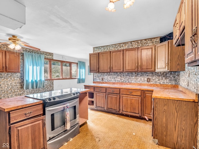 4484 S County Road 315 W, Greencastle, IN 46135 - kitchen featuring stainless steel range with electric cooktop, brown cabinets, tasteful backsplash, and a ceiling fan