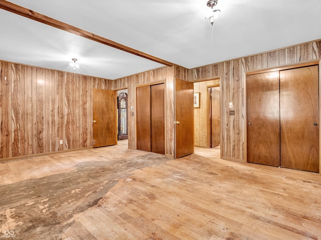 4484 S County Road 315 W, Greencastle, IN 46135 - unfurnished bedroom featuring wooden walls, wood-type flooring, and multiple closets