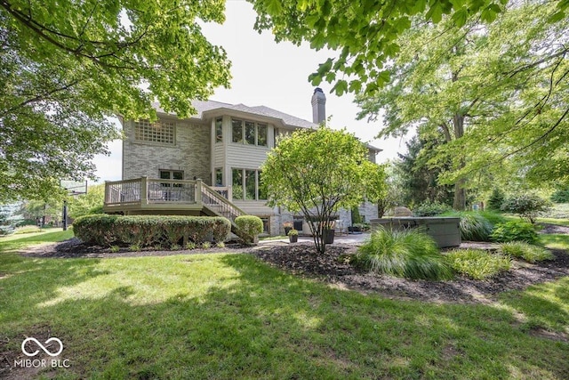 13023 Water Ridge Dr, Mccordsville, IN 46055 - rear view of property with stone siding, a chimney, a deck, a lawn, and stairs