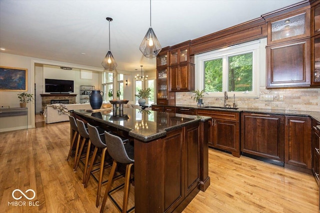 13023 Water Ridge Dr, Mccordsville, IN 46055 - kitchen featuring a kitchen bar, a center island, decorative backsplash, and plenty of natural light