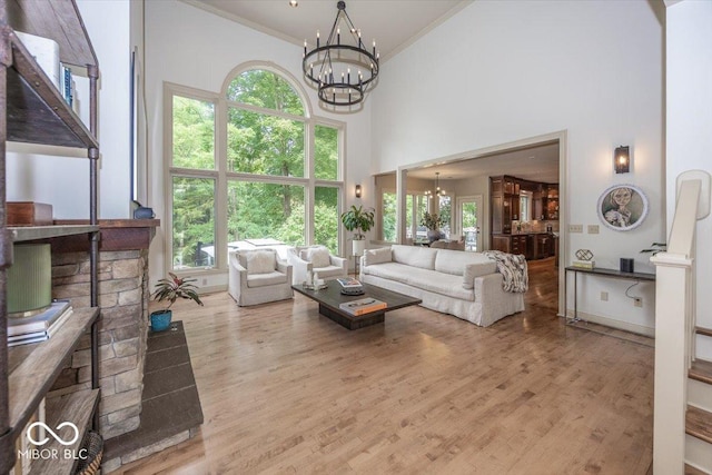 13023 Water Ridge Dr, Mccordsville, IN 46055 - living room with a chandelier, crown molding, a towering ceiling, and wood finished floors