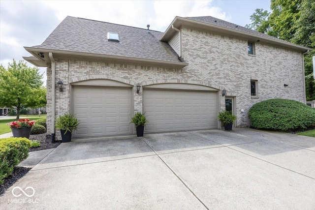 13023 Water Ridge Dr, Mccordsville, IN 46055 - view of property exterior with concrete driveway, a garage, a shingled roof, and brick siding
