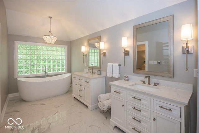 13023 Water Ridge Dr, Mccordsville, IN 46055 - bathroom with marble finish floors, two vanities, a freestanding tub, and lofted ceiling