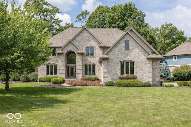13023 Water Ridge Dr, Mccordsville, IN 46055 - french provincial home with a front lawn, brick siding, and roof with shingles