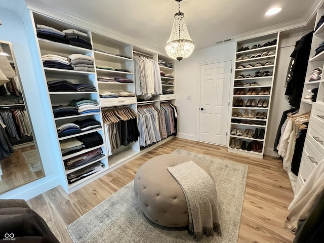 13023 Water Ridge Dr, Mccordsville, IN 46055 - walk in closet with a chandelier and light wood-type flooring
