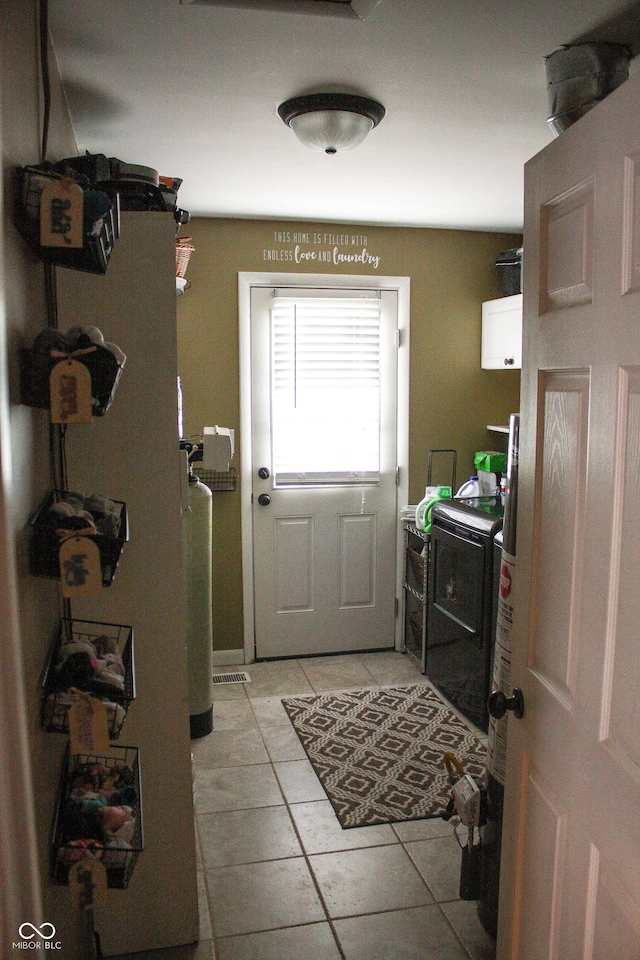 1042 S County Road 600 W, Danville, IN 46122 - doorway with washer / dryer and light tile patterned floors