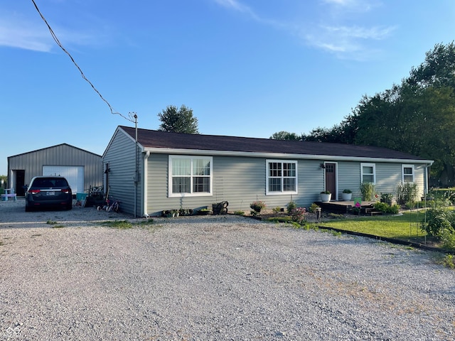 1042 S County Road 600 W, Danville, IN 46122 - ranch-style home with a garage, gravel driveway, and an outbuilding