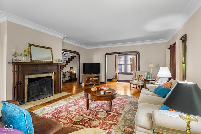 613 5th St, Columbus, IN 47201 - living room with arched walkways, ornamental molding, wood finished floors, and a fireplace