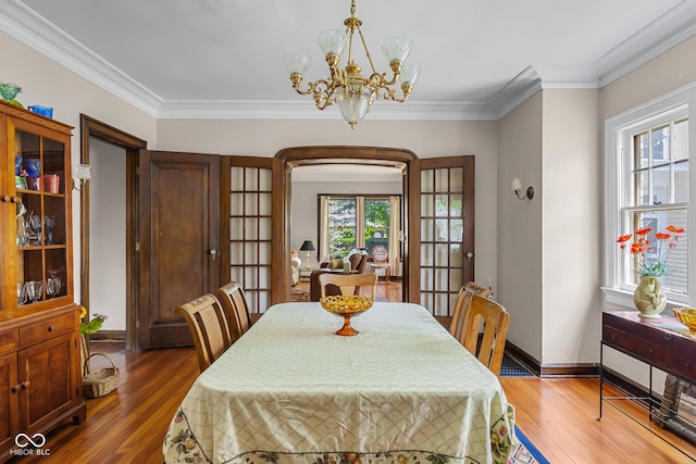 613 5th St, Columbus, IN 47201 - dining area with hardwood / wood-style flooring, a chandelier, and crown molding