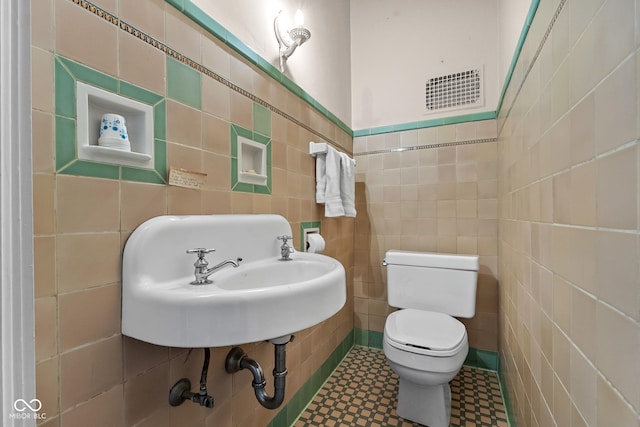 613 5th St, Columbus, IN 47201 - bathroom with tile walls and tile patterned floors