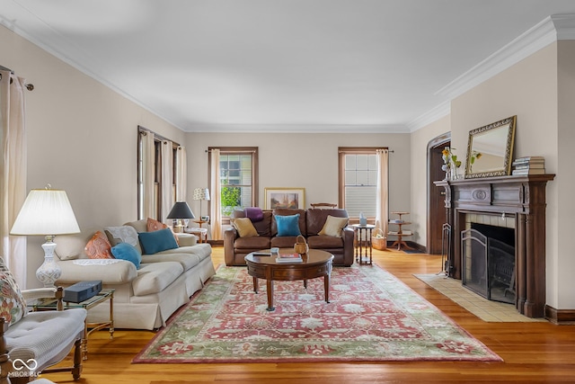 613 5th St, Columbus, IN 47201 - living area featuring ornamental molding, light wood finished floors, and a tile fireplace