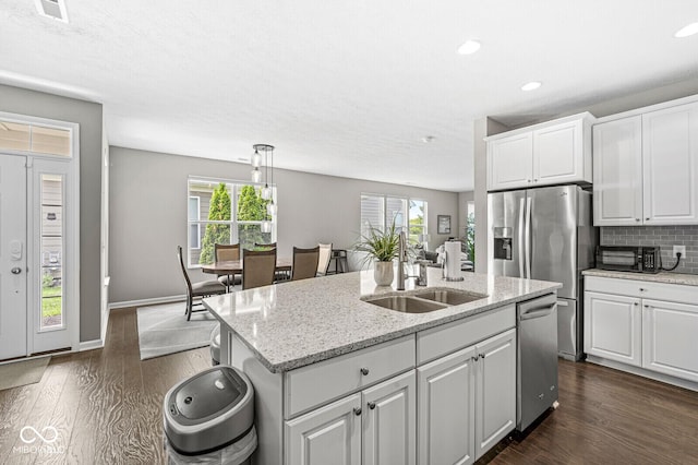 10868 Matherly Way, Noblesville, IN 46060 - kitchen featuring stainless steel appliances, dark wood-style floors, healthy amount of natural light, and recessed lighting