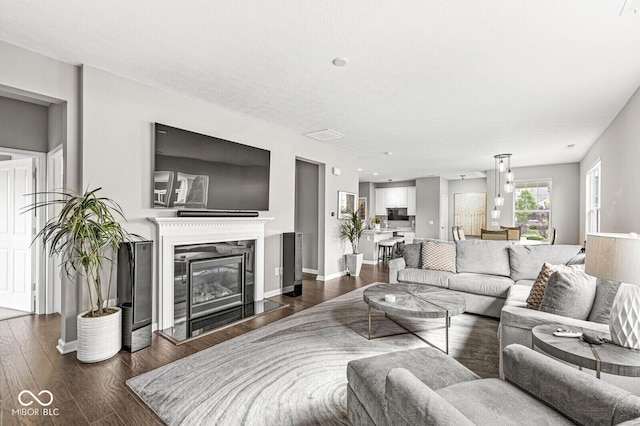 10868 Matherly Way, Noblesville, IN 46060 - living area with dark wood-style flooring and a glass covered fireplace