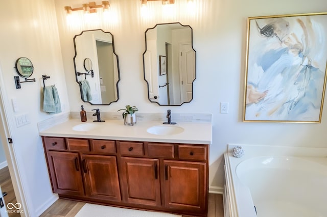 6802 Chorleywood Cir, Indianapolis, IN 46259 - full bathroom featuring double vanity, a garden tub, and wood finished floors