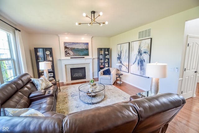 6802 Chorleywood Cir, Indianapolis, IN 46259 - living room with a chandelier, wood finished floors, and a fireplace