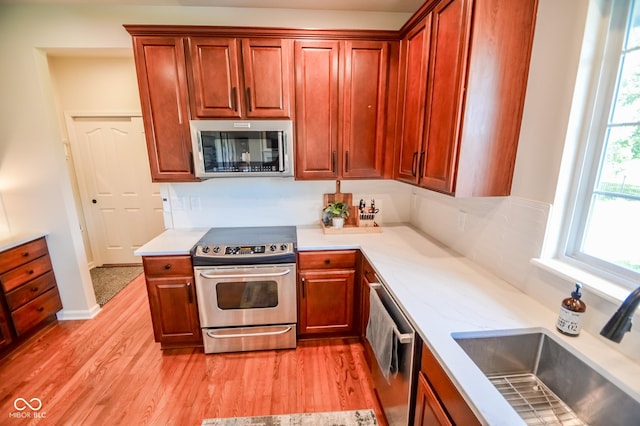 6802 Chorleywood Cir, Indianapolis, IN 46259 - kitchen with stainless steel appliances, light wood-style flooring, and light countertops