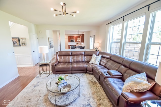 6802 Chorleywood Cir, Indianapolis, IN 46259 - living room featuring a chandelier, wood finished floors, and wainscoting