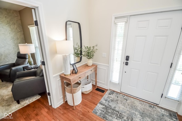 6802 Chorleywood Cir, Indianapolis, IN 46259 - entrance foyer featuring wainscoting, wood finished floors, and a decorative wall