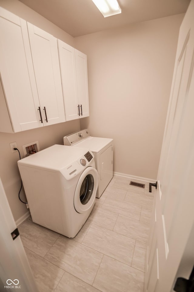 6802 Chorleywood Cir, Indianapolis, IN 46259 - laundry area with washing machine and clothes dryer and cabinet space