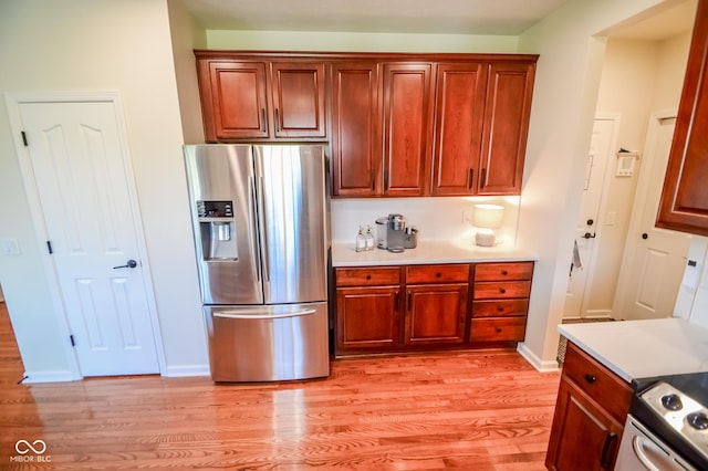 6802 Chorleywood Cir, Indianapolis, IN 46259 - kitchen with appliances with stainless steel finishes, light wood-type flooring, light countertops, and brown cabinets