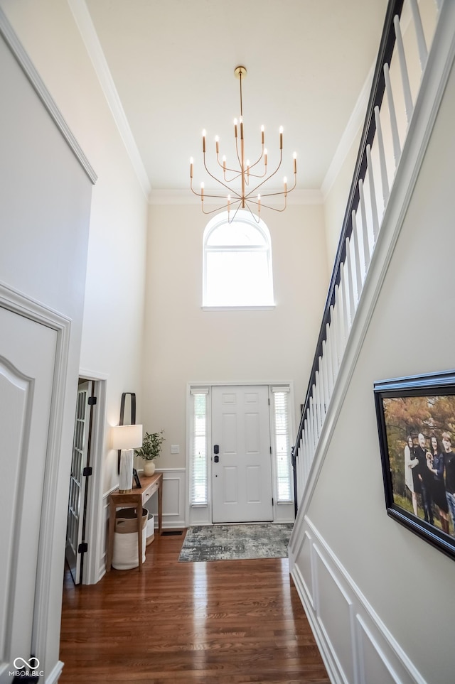 6802 Chorleywood Cir, Indianapolis, IN 46259 - entryway featuring ornamental molding, a chandelier, wood finished floors, stairs, and a towering ceiling