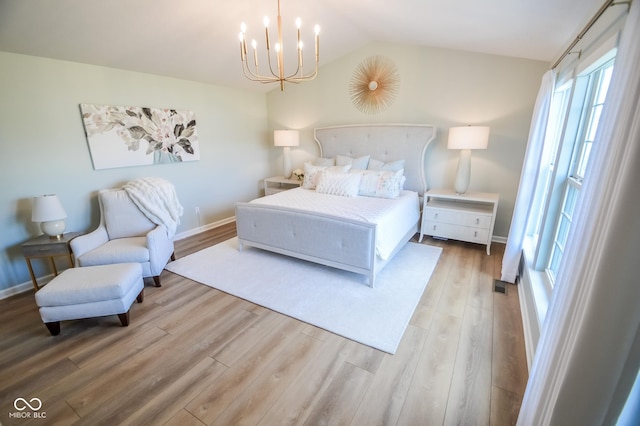 6802 Chorleywood Cir, Indianapolis, IN 46259 - bedroom featuring a chandelier, wood finished floors, and lofted ceiling