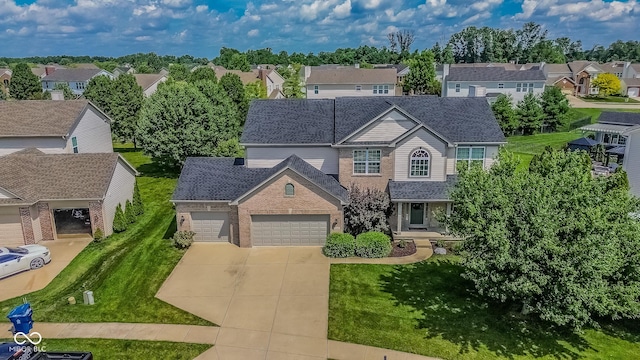 6802 Chorleywood Cir, Indianapolis, IN 46259 - traditional home with a garage, brick siding, driveway, a residential view, and a front yard