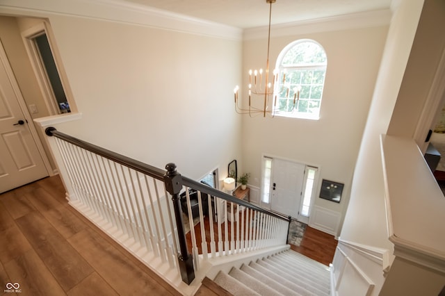 6802 Chorleywood Cir, Indianapolis, IN 46259 - stairs with a chandelier, wood finished floors, and ornamental molding