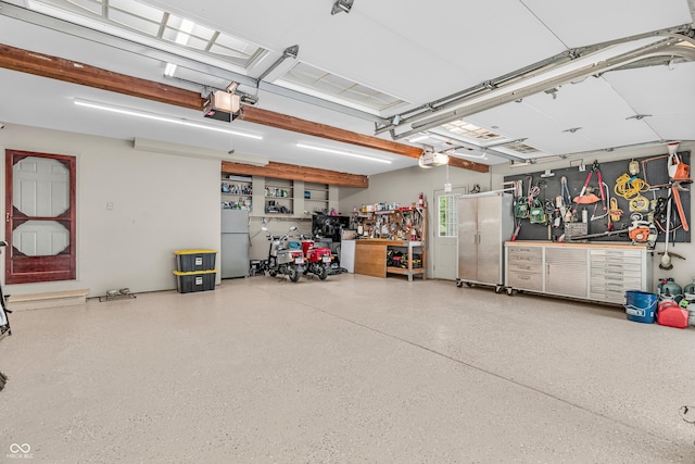 5052 Sherwood Ct, Pittsboro, IN 46167 - garage with a workshop area, a garage door opener, and freestanding refrigerator
