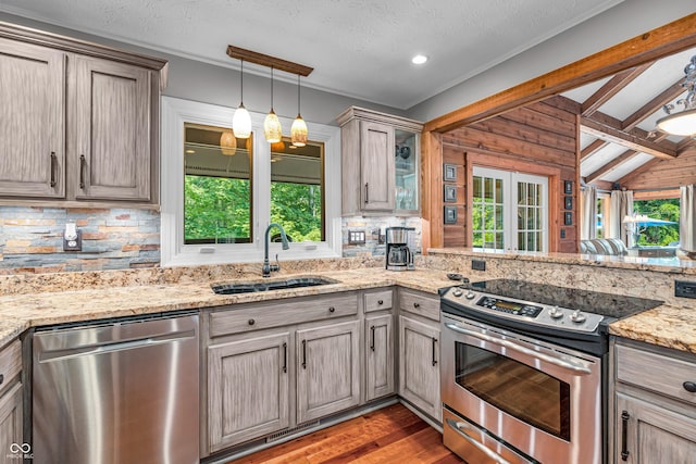 5052 Sherwood Ct, Pittsboro, IN 46167 - kitchen with appliances with stainless steel finishes, healthy amount of natural light, tasteful backsplash, lofted ceiling, and a textured ceiling