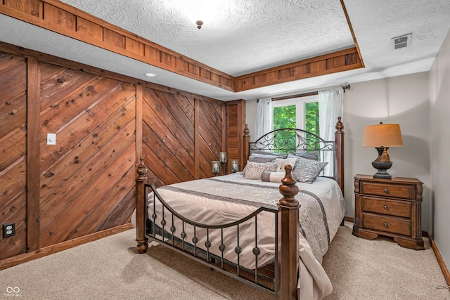 5052 Sherwood Ct, Pittsboro, IN 46167 - bedroom featuring light carpet, a textured ceiling, and wooden walls