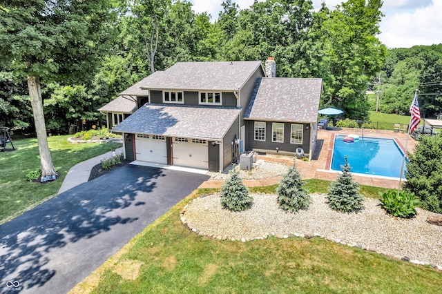 5052 Sherwood Ct, Pittsboro, IN 46167 - view of front of property with driveway, a chimney, a shingled roof, and a garage