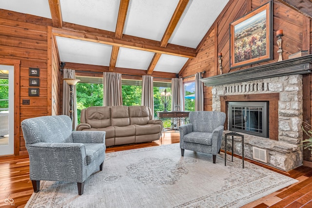 5052 Sherwood Ct, Pittsboro, IN 46167 - living area featuring healthy amount of natural light, wood-type flooring, a fireplace, and wood walls