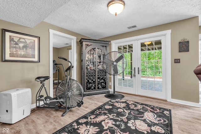 5052 Sherwood Ct, Pittsboro, IN 46167 - exercise room with a textured ceiling, wood finished floors, and french doors