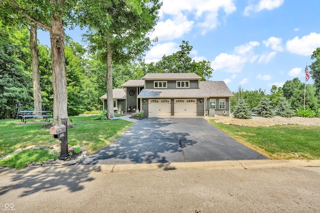 5052 Sherwood Ct, Pittsboro, IN 46167 - view of front of property featuring asphalt driveway, a front yard, an attached garage, and view of wooded area