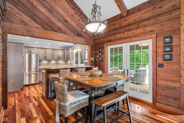 5052 Sherwood Ct, Pittsboro, IN 46167 - dining space featuring hardwood / wood-style flooring, french doors, wooden walls, and lofted ceiling