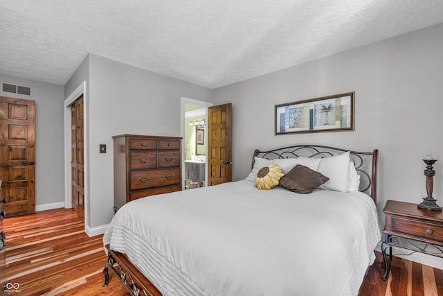 5052 Sherwood Ct, Pittsboro, IN 46167 - bedroom with wood finished floors and a textured ceiling