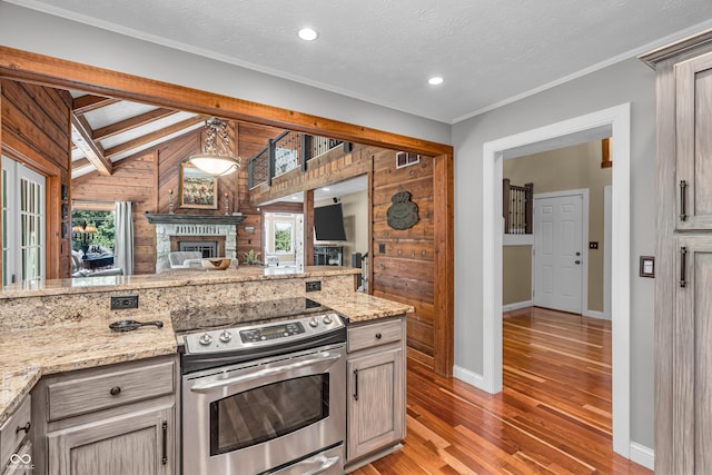 5052 Sherwood Ct, Pittsboro, IN 46167 - kitchen featuring stainless steel electric stove, light wood-style flooring, open floor plan, light stone counters, and recessed lighting
